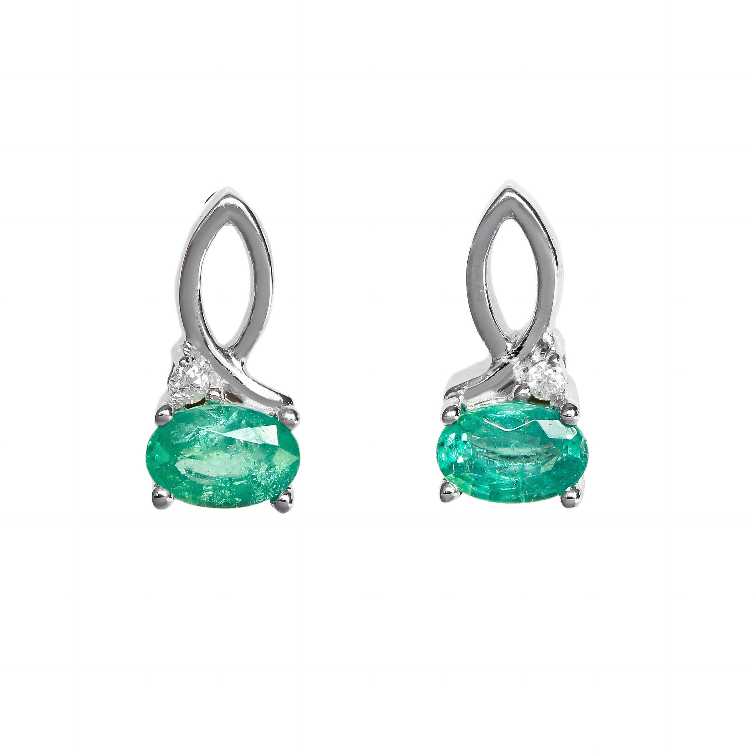 A product photo of a pair of emerald and diamond earrings in 9k white gold on a white background. The 6x4mm emeralds are horizontally-oriented, and hang by elegant loops of white gold - decorated with a single white diamond on the outer edge of each earring.