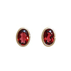 A product photo of a pair of garnet earrings in 9ct yellow gold sitting on a white background. The fine 6x4mm garnet jewels are framed in a thick layer of yellow gold in a bezel setting.