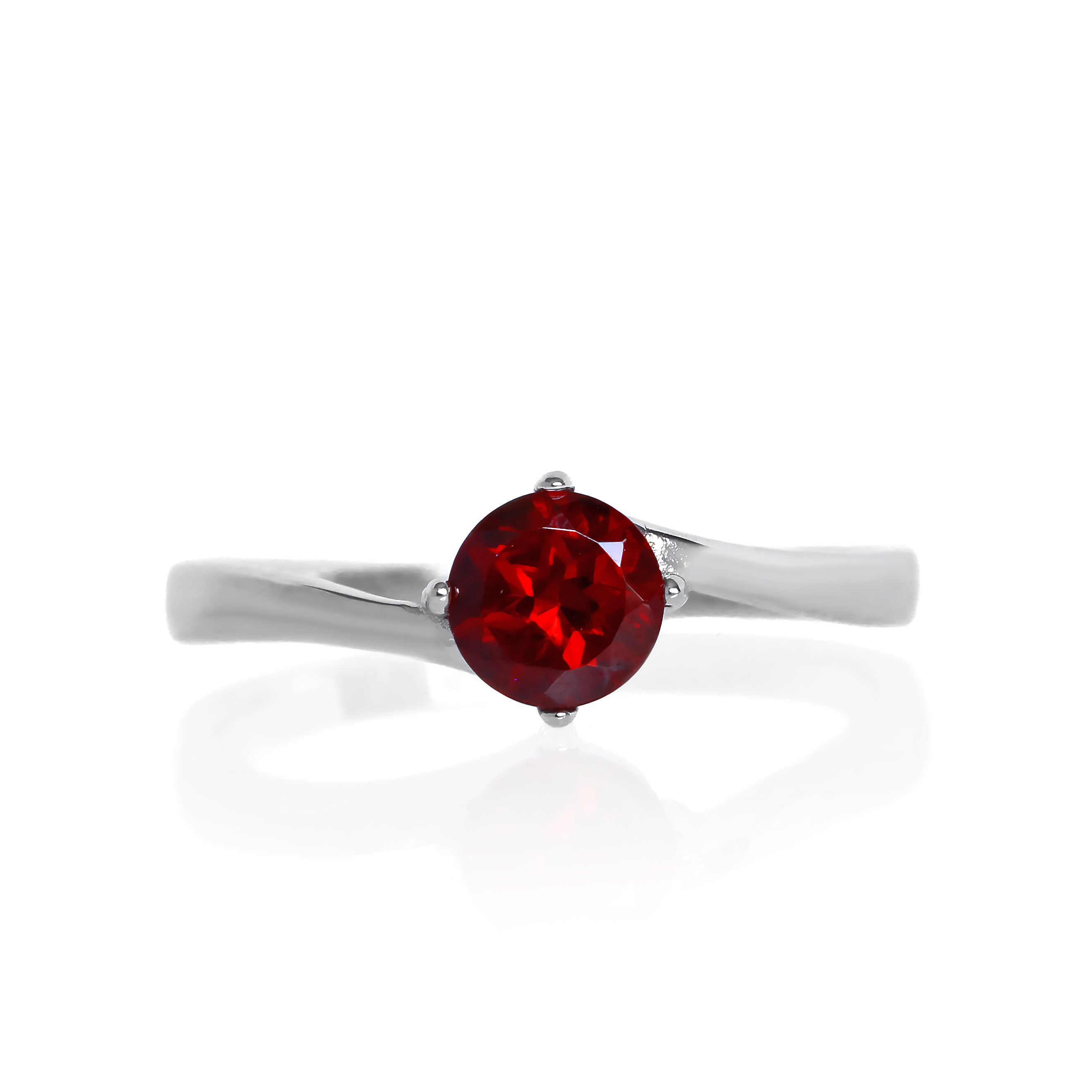 A product photo of a curved-band silver solitaire ring with a crimson red garnet centre stone sitting on a white background. The deep red gemstone colour would be a good ruby alternative.