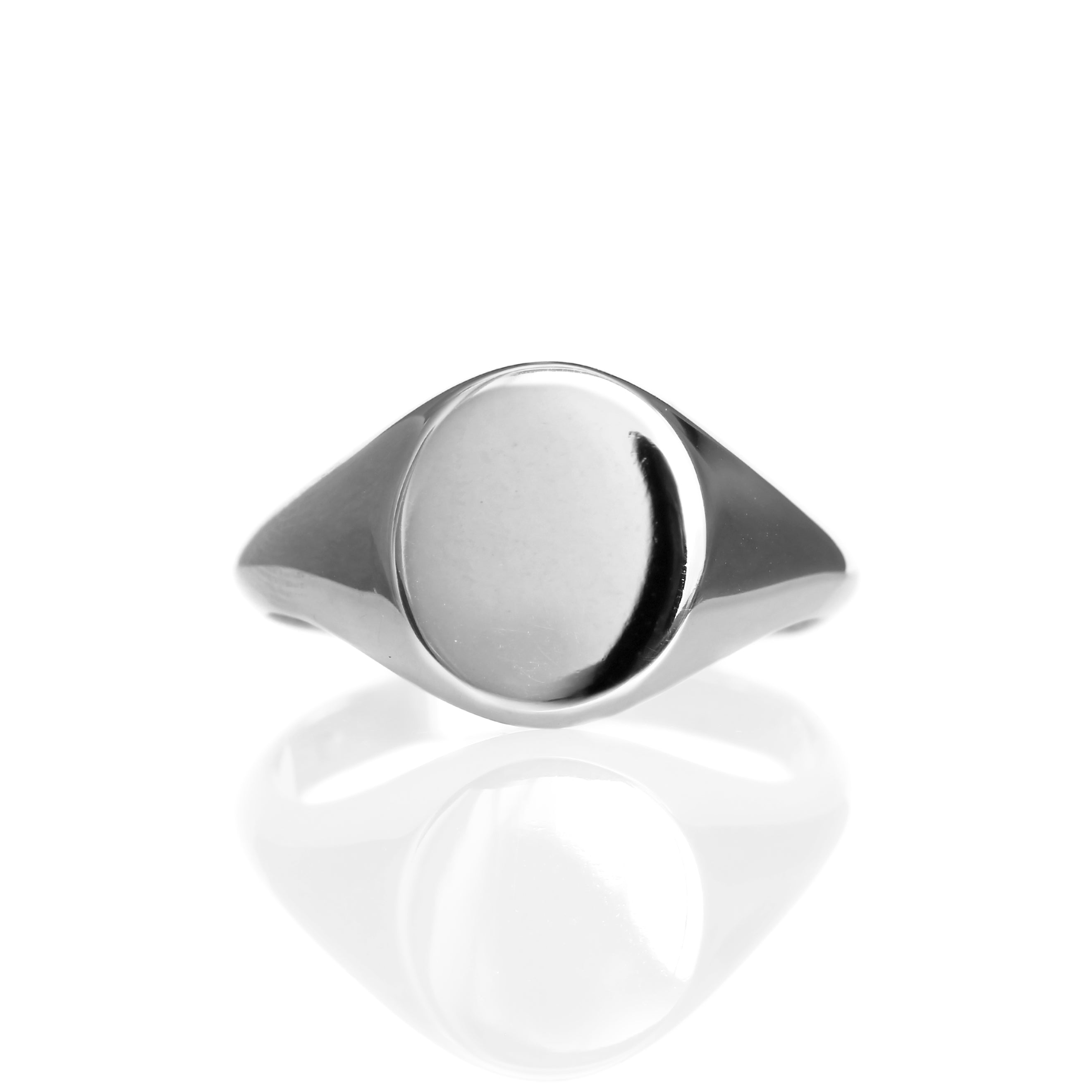 A product photo of a mens' signet ring made of 9k white gold on a white background. The face of the ring is an 12x10mm flat ovoid that transitions to a thick rounded band.