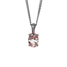 A product photo of a silver pink morganite pendant suspended by a silver chain against a white background. The oval gemstone is held in place by 4 small claws, and reflects baby pink hues from its many edges