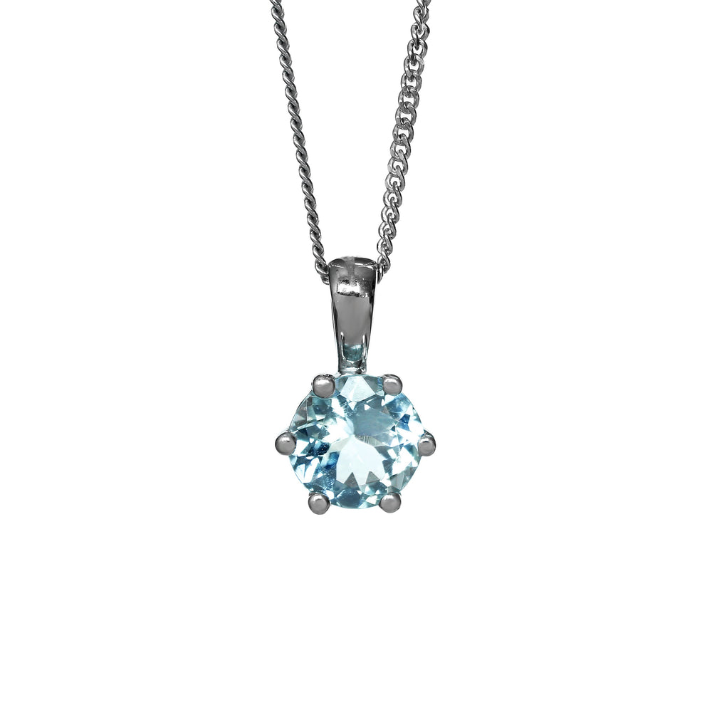 A product photo of a silver aquamarine pendant against a white background. The highly-reflective round cut aquamarine stone is held in place by 6 dainty silver claws. It is suspended by a simple silver chain.