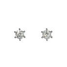 A product photo of a pair of dazzling lab diamond earrings on a white background. The stones are each a stunningly-bright 0.50ct round brilliant-cut jewel, and are each perfectly secured in place by 6 delicate 14 karat white gold claws. The earrings would make an excellent birthday gift for a wearer born in April, given the diamond birthstone in its centre, or as a thoughtful anniversary gift.