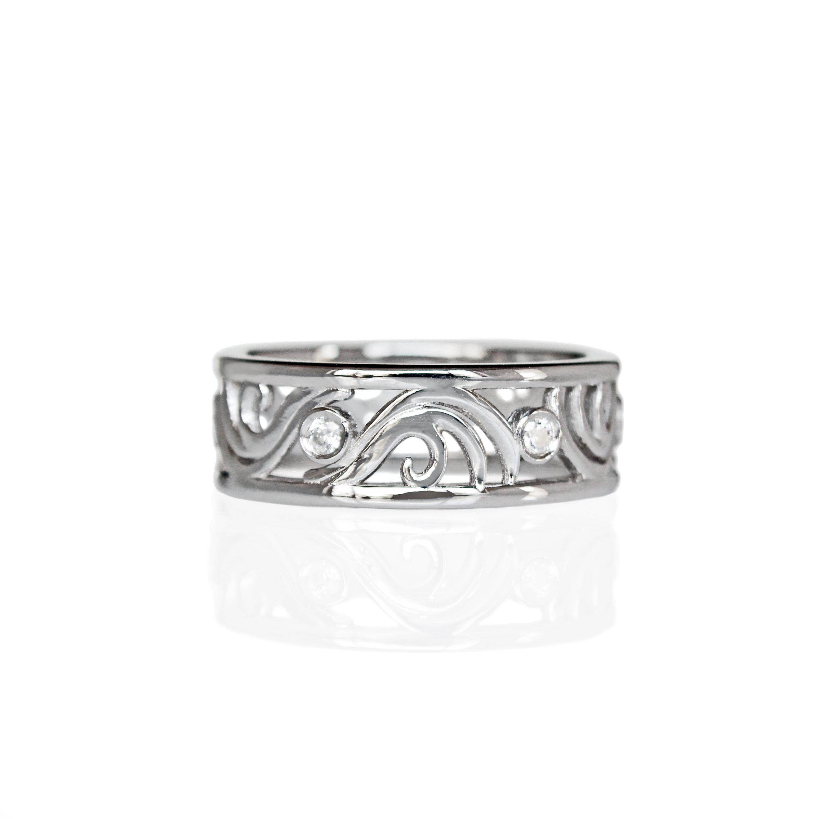 A product photo of a filigree detailed unisex wedding band in solid 925 sterling silver on a white background. The filigree patterning is swirling and floral, reminiscent of a baroque wallpaper, and is punctuated by 6 total 0.03ct dazzling white moissanite gemstones worked into the filigree detailing, each held in place by a bezel setting. 