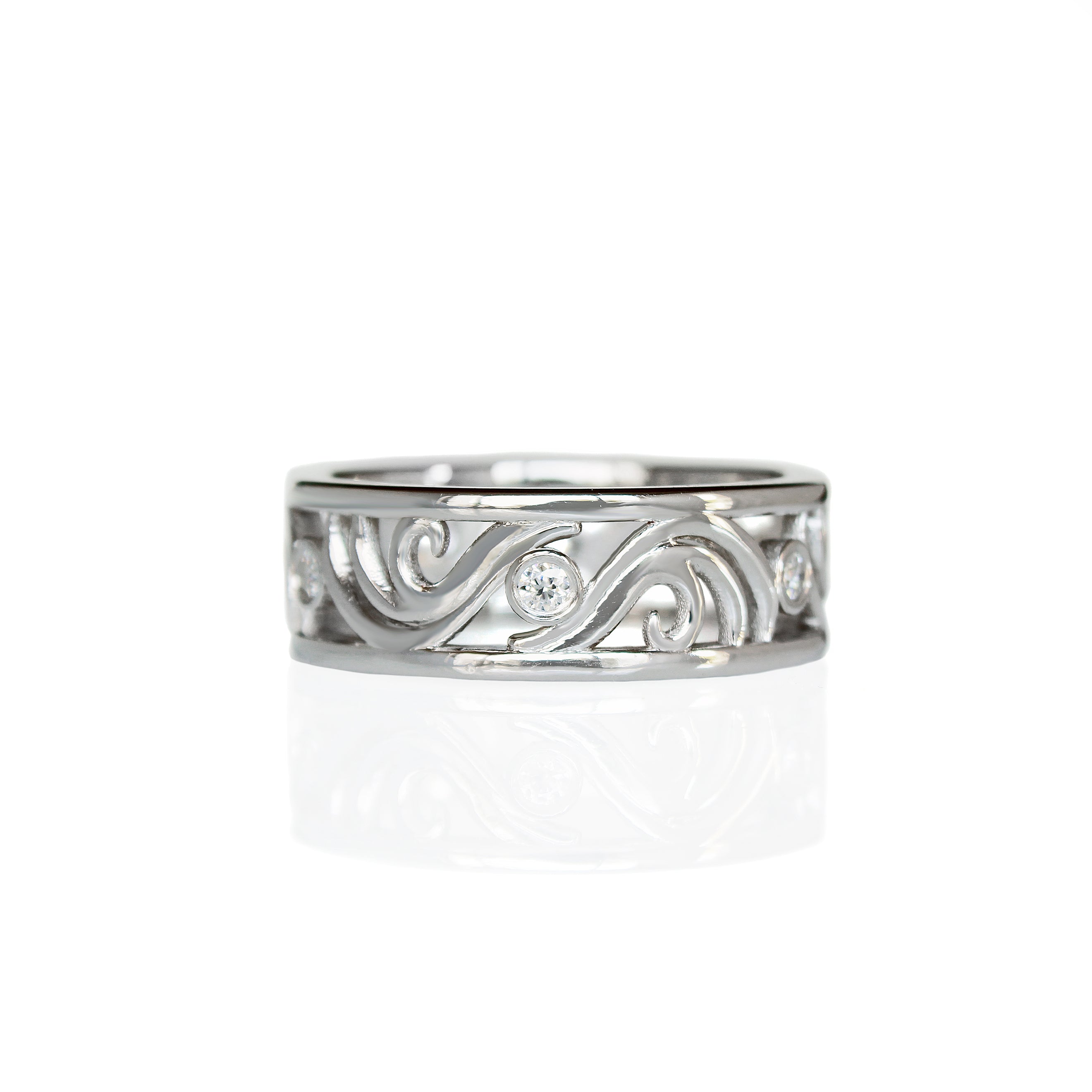 A product photo of a filigree detailed unisex wedding band in solid 925 sterling silver on a white background. The filigree patterning is swirling and floral, reminiscent of a baroque wallpaper, and is punctuated by 6 total 0.03ct dazzling white moissanite gemstones worked into the filigree detailing, each held in place by a bezel setting. 