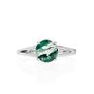 A product photo of moss agate solitaire ring in solid 9k white gold on a white background. The band is split into two prongs, meeting on either side of the 7mm round faceted moss agate jewel.