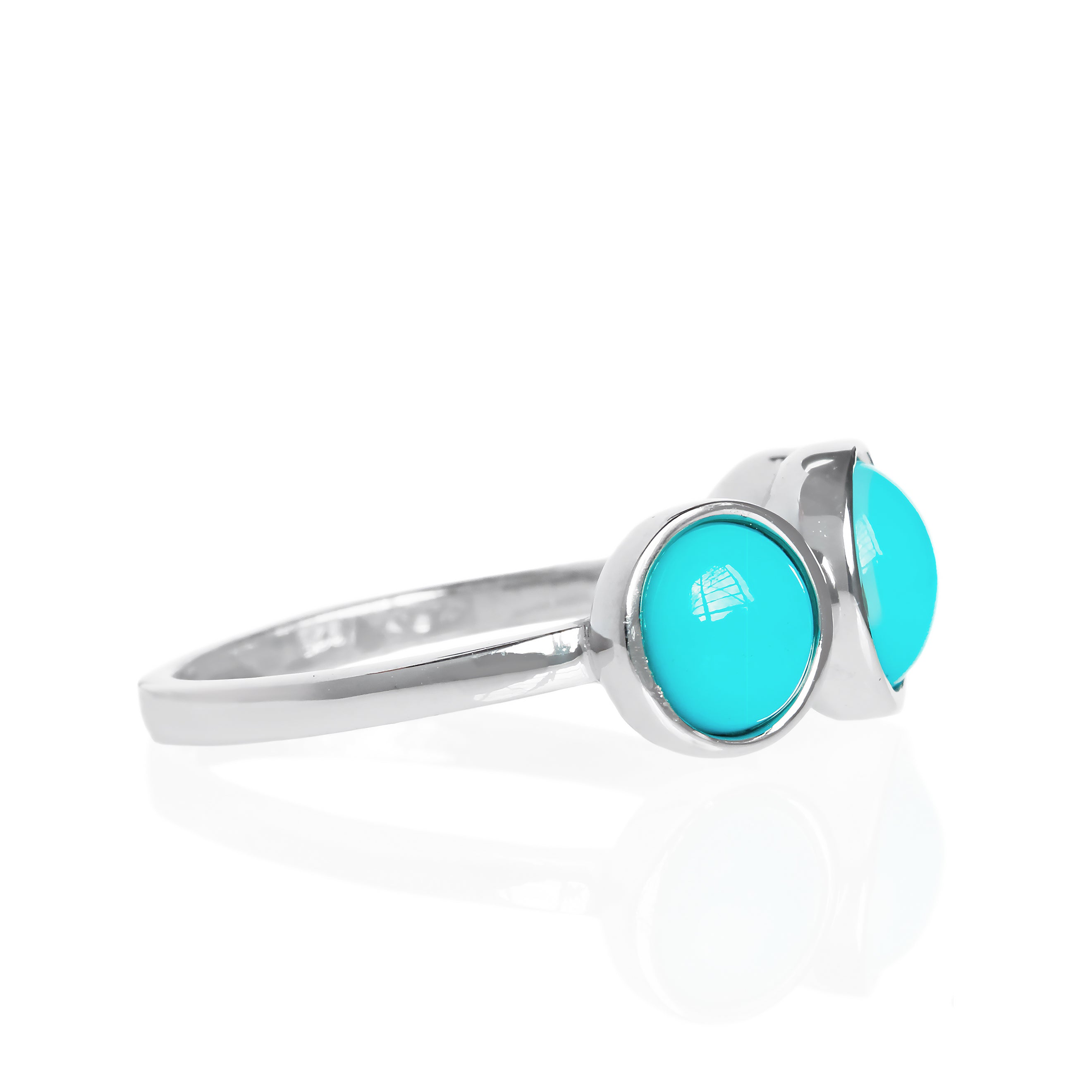 A product photo of a turquoise silver ring on a white background. The ring consists of 3 stones total, 2 are 6mm in width, the centre stone being 7mm, each encased in a layer of silver bezel setting. The 3 cabochon-cut blue turquoise stones hail straight from the Sleeping Beauty mountains of Arizona. 