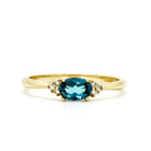 A dainty and elegant golden ring with a stunning combination of topaz and diamond detailing.