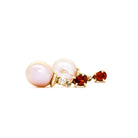 A product photo of delicate rosaline pearl earring studs on a white background. The rosaline pearls each have diamond detailing above them and a pear-shaped garnet gem connecting both to the yellow gold stud.