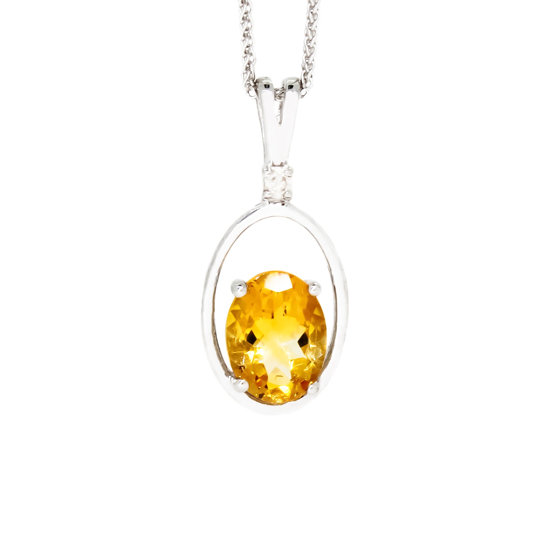    A product photo of a silver pendant with an circle-cut citrine centre stone suspended by a silver chain against a white background. The circular citrine stone rests at the bottom of a silver frame in the shape of a teardrop. The citrine jewel is almost honey-coloured, reflecting a warm orangey yellow colour across its multi-faceted surface.