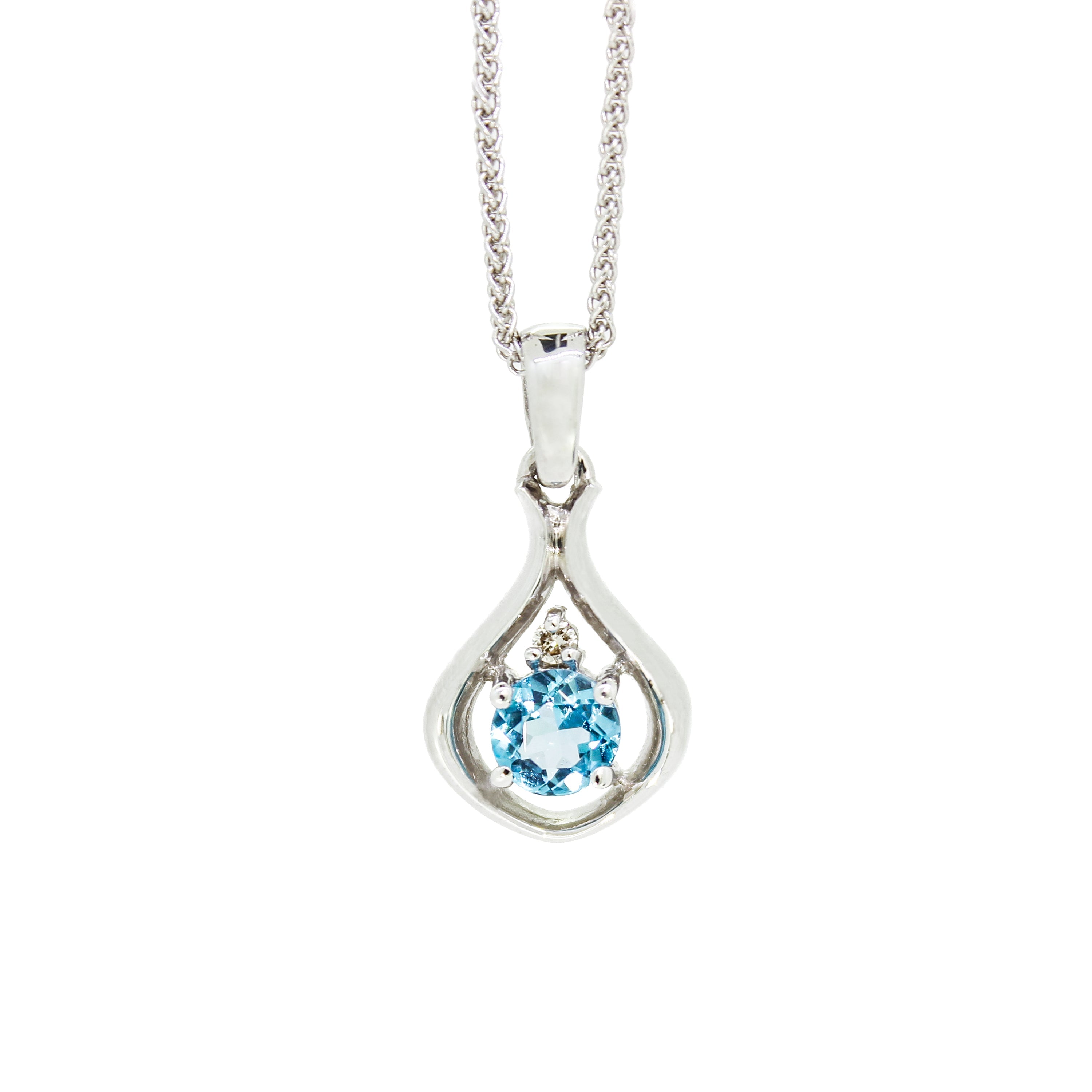 A product photo of a silver pendant with a light blue topaz centre stone. The stone sits at the base of a silver teardrop shape, with a small diamond positioned above it. The pendant is suspended by a silver chain against a white background.