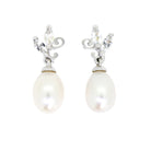 A product photo of a pair of ornate pearl drop stud earrings in white gold suspended over a white background. The large pearls are creamy white and teardrop-shaped, with two small marquise-cut silver topaz stones and subtle filigree detailing on each piece linking them to the back of the golden stud.