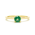 A product photo of a simple 9k yellow gold solitaire ring with a mint green tourmaline centre stone sitting on a white background. The green gemstone colour be a good emerald substitute.