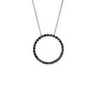 A product photo of a solid 9ct white gold and black diamond pendant suspended by a golden chain against a white background. The design is made up of 30 black diamond jewels arranged in a perfect hollow circle, reminiscent of an abstract ouroboros jewellery design. All of the diamonds are held in place by delicate golden claws.