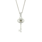 A product photo of a ceremonial diamond key pendant set in solid 9ct white gold. The design is dainty and left purposefully vague, so it may serve as a traditional 21st birthday present or as a key to something special to the wearer. The design consists of smooth and simple gold, with an oval-shaped loop framing a single round bezel-set diamond as the bow of the key, almost resembling an eye, while the rest of the key's design is simple and classic.