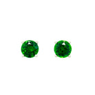 A product photo of 5.5mm Round Tsavorite Earring Studs in 9k White Gold sitting on a plain white background. The stones are held in place by 4 delicate golden claws. The tsavorites reflect electric green hues across their multi-faceted edges.