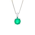 A product photo of a white gold emerald pendant suspended by a chain against a white background. The round stone is held in place by 4 small claws, and reflects ocean green hues from its many edges.