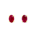 A product photo of 6x4mm Oval Shaped Ruby Earring Studs in 9k Yellow Gold sitting on a plain white background. The 2 ruby stones measure 4mm across and are deep red, reflecting sanguine and magenta hues across their multi-faceted edges, and are each held in place by dainty golden claws.