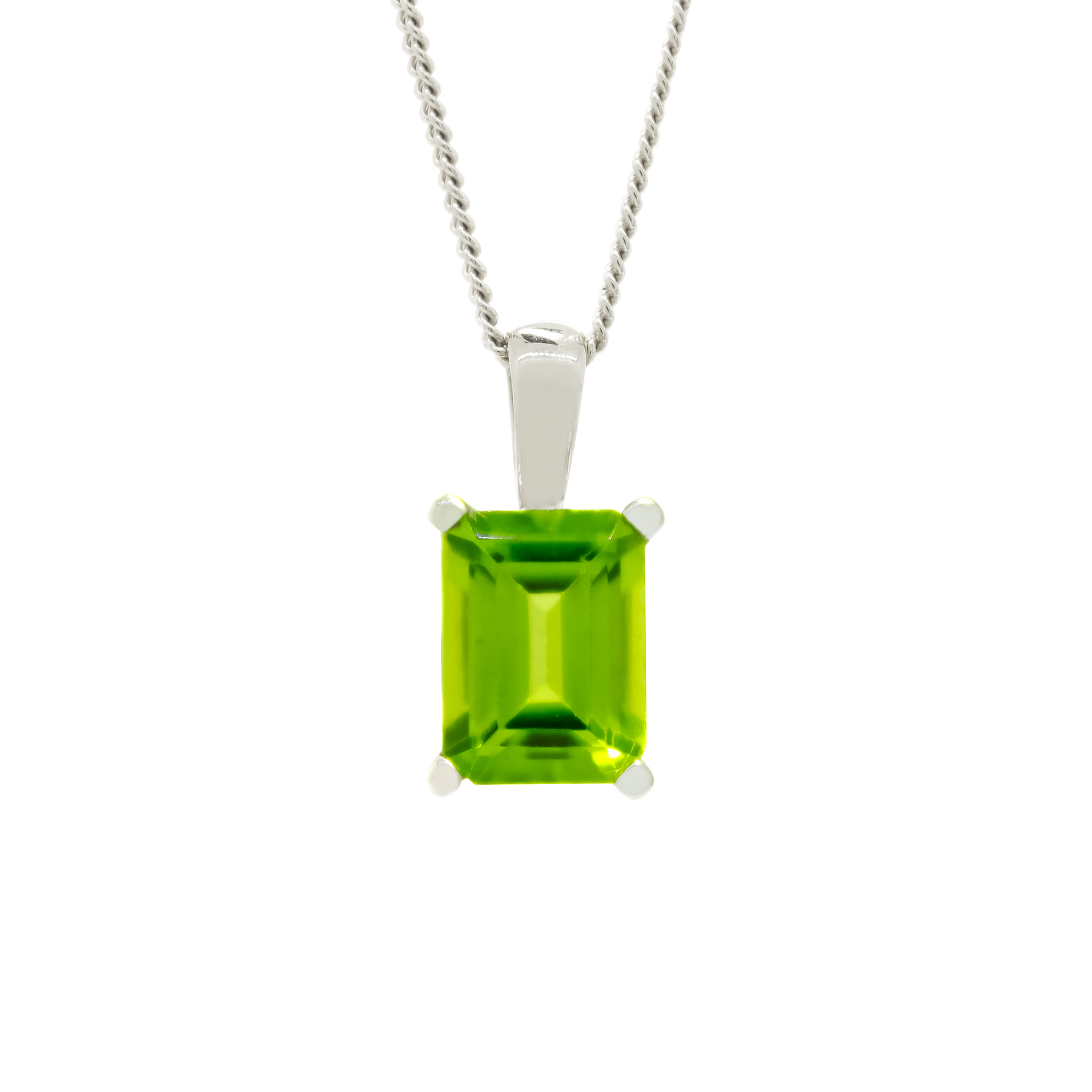 A product photo of a 8x6mm Rectangular Peridot Pendant in 9ct White Gold suspended against a white background. The impressively large and brightly-coloured stone is contrasted by its overall minimalistic design, 4 simple golden claws holding the gem in place. It is suspended by a simple gold chain. The stone is a bright green colour, reflecting chartreuse hues across its multi-faceted edges.