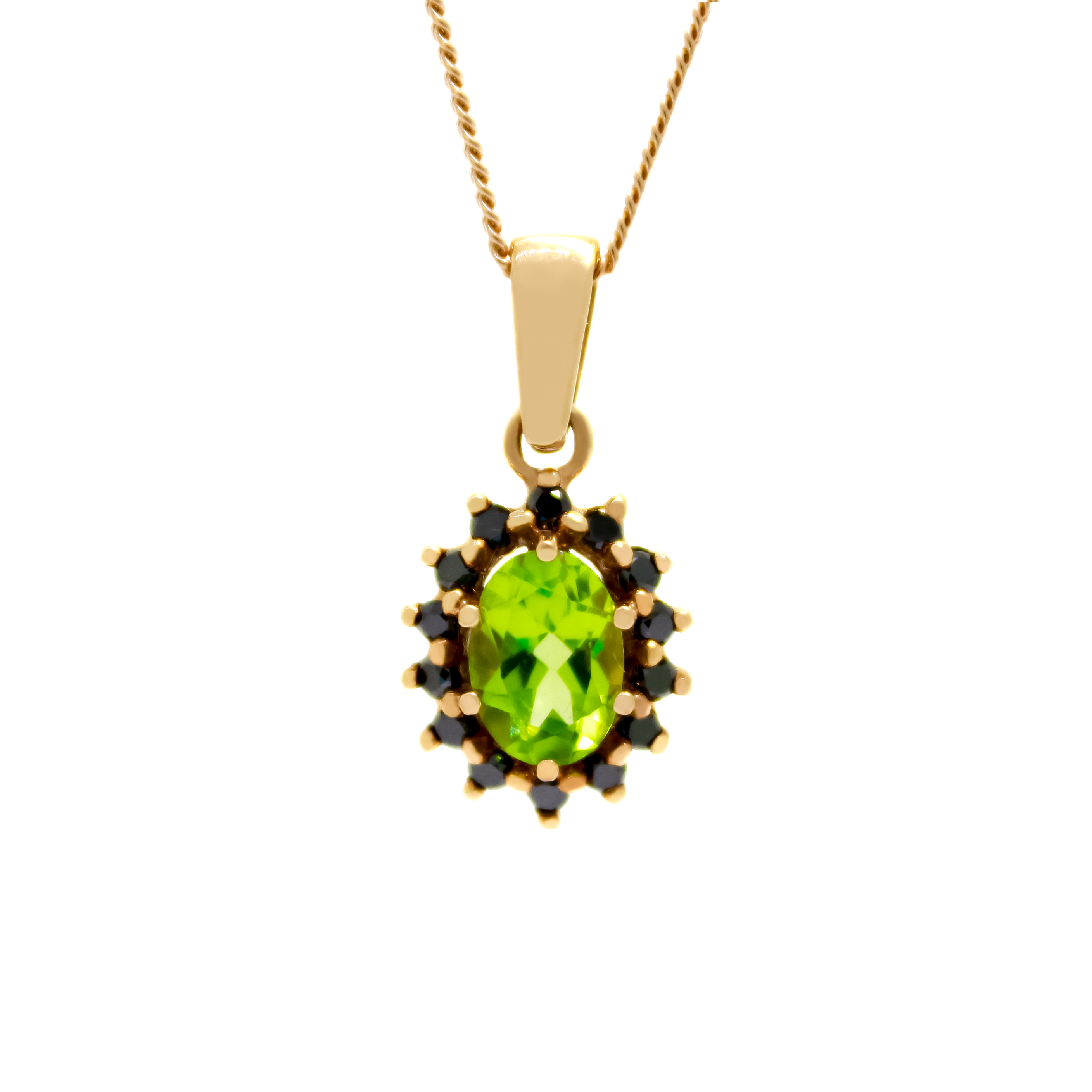 A product photo of a lavishly ornate peridot pendant bejewelled with a black diamond halo in solid 9ct rose gold suspended by a golden chain against a white background. The large peridot gemstone is oval-shaped, and is surrounded by a star-like halo of rose gold and black diamond details.