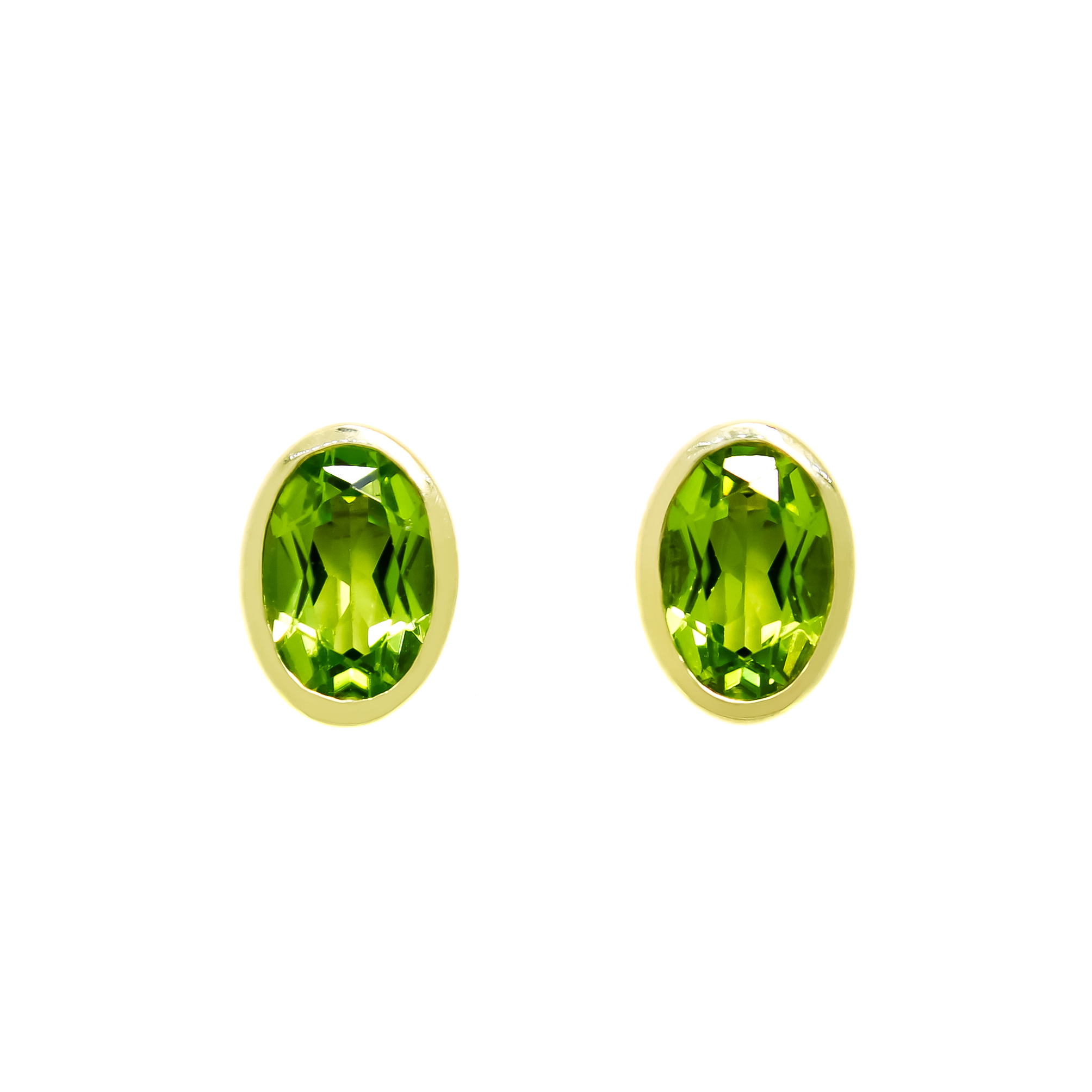 A product photo of a pair of peridot earrings in 9ct yellow gold sitting on a white background. The fine 6x4mm peridots are framed in a thick layer of yellow gold in a bezel setting.