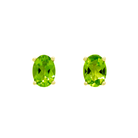 A product photo of 7x5mm Oval Shaped Peridot Earring Studs in 9k Yellow Gold sitting on a plain white background. The 2 peridot stones measure 5mm across and are a bright grassy green, reflect chartreuse hues across their multi-faceted edges, and are each held in place by dainty golden claws.