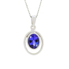 A product photo of a Bezel-set Tanzanite Pendant in 9ct White Gold sitting on a plain white background. The bezel-set stone is nestled at the top of a golden oval loop of similar thickness to the bezel frame. The tanzanites reflect violet and indigo hues across their multi-faceted edges.