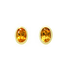 A product photo of a pair of citrine earrings in 9ct yellow gold sitting on a white background. The fine 6x4mm citrines are framed in a thick layer of yellow gold in a bezel setting.