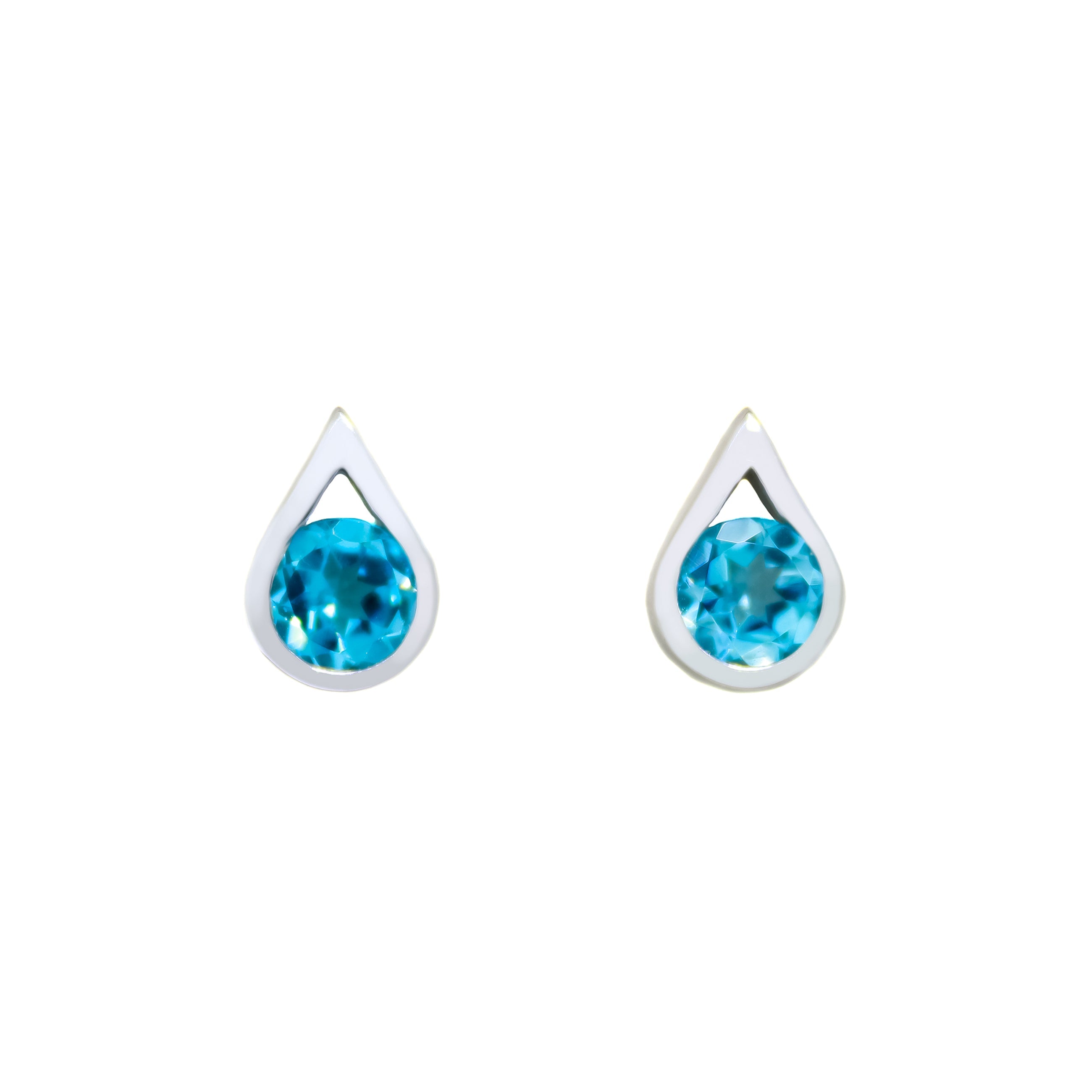 A product photo of 9ct yellow gold blue topaz stud earrings sitting on a white background. The round stones are encased by thick, yellow gold frames in the shapes of teardrops. The bright blue topaz stones reflect tropical sky blue light from their many edges.