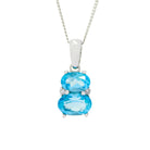 A product photo of a blue topaz and diamond necklace in 9k white gold sitting on a white background. The pendant is made up of two horizontal oval-shaped blue topaz stones, the bottom one being 7x5mm and the top being 6x4mm. The spaces between the two stones are filled with one small diamond on either side.