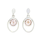 A product photo of 5.5mm Round Bezel-set Morganite Earring Studs in 9 karat White Gold sitting on a plain white background. The bezel-set stones are nestled at the top of golden oval loops of similar thickness to the bezel frames. The morganites reflect pale pink hues across their multi-faceted edges.