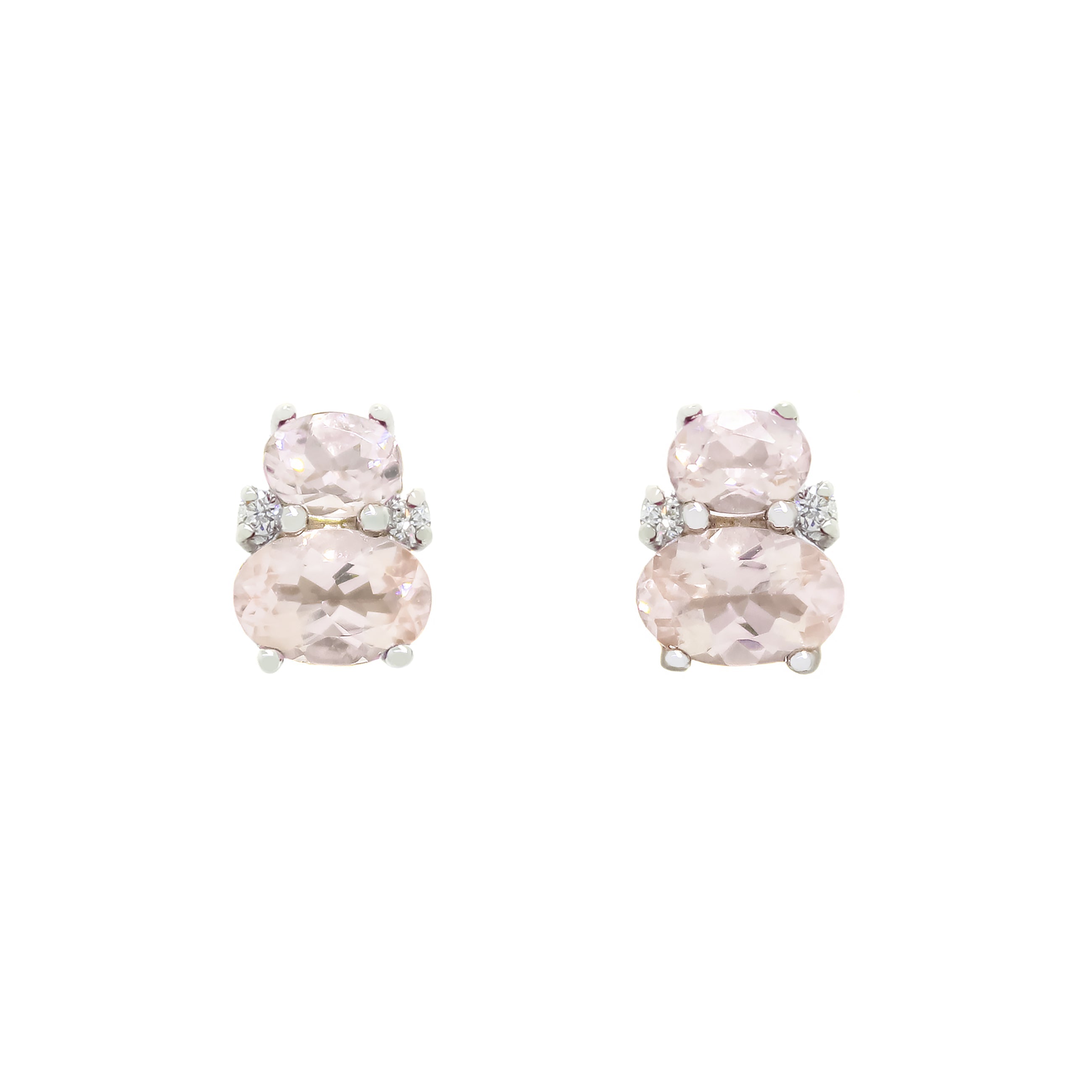 A product photo of a pair of 9 karat white gold morganite earrings sitting against a white background. One smaller pink gemstone oval is stacked upon a larger oval on each earring, with the area where the two stones make contact decorated by a single small diamond on either side.