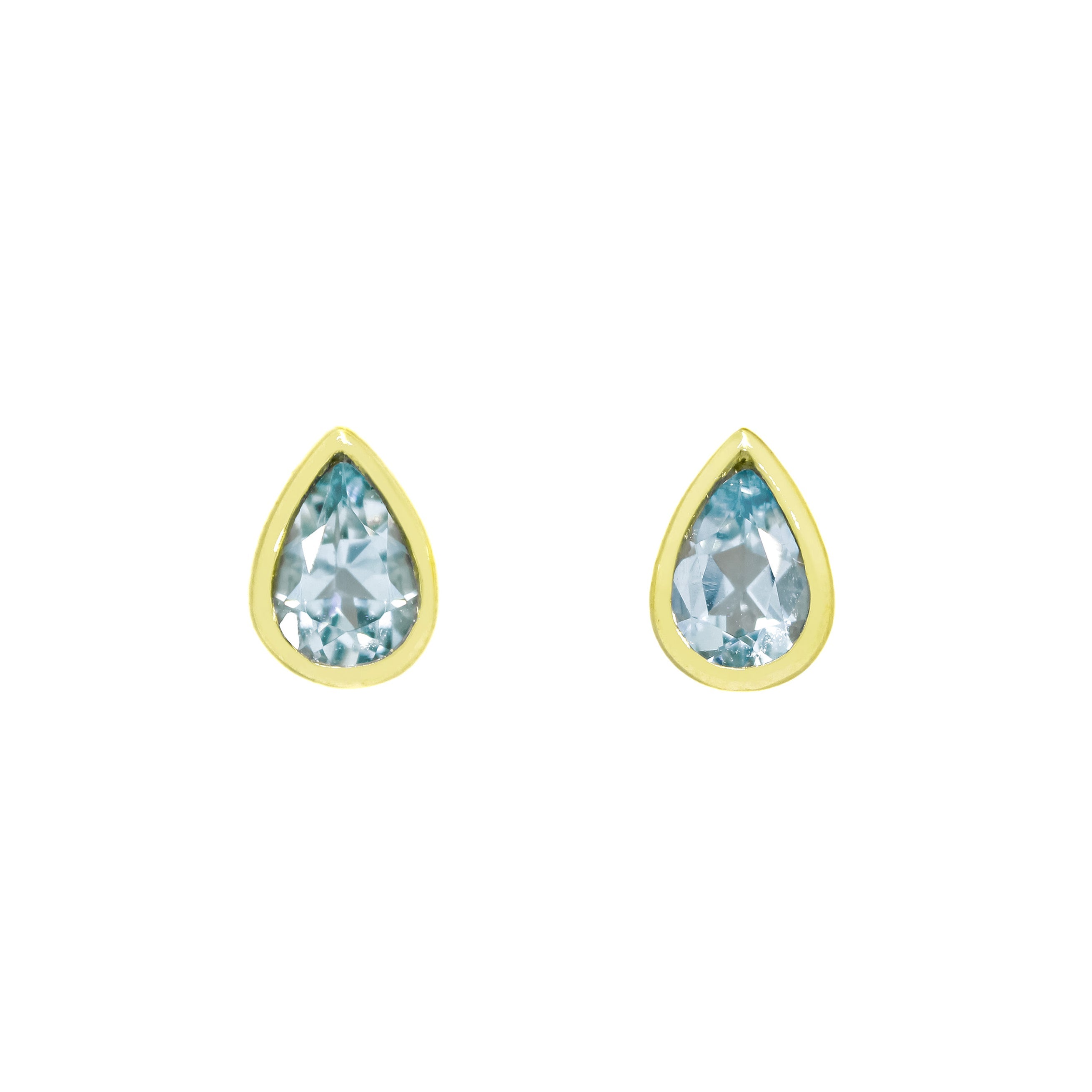 A product photo of 9ct yellow gold aquamarine stud earrings sitting on a white background. The pear-shaped stones are encased by thick, yellow gold frames in the shapes of teardrops. The pale blue aquamarine stones reflect baby blue light from their many edges.