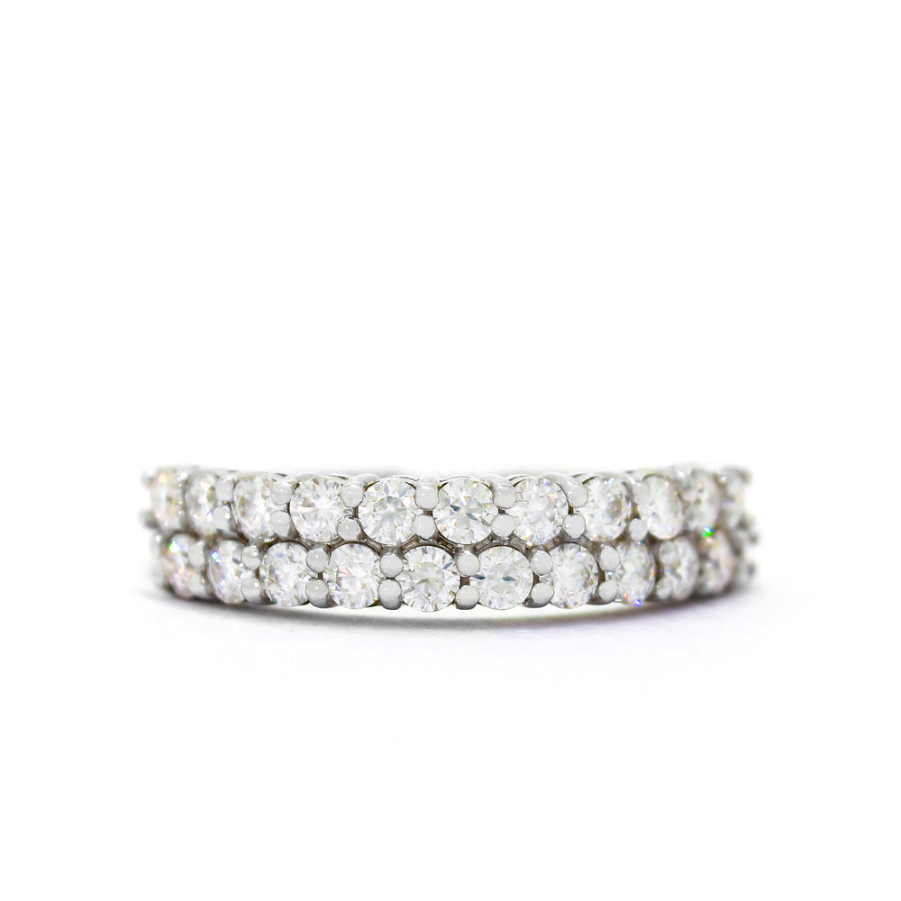 A product photo of a solid 2-tiered 9ct white gold and moissanite eternity ring sitting on a white background. The face of the ring is made up of 2 offset rows of 22 0.05ct moissanites in total.