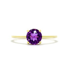 A product photo of an amethyst solitaire riing in 9 karat solid yellow gold sitting on a white background. The deep purple gemstone measures 6mm across, and reflects breathtaking pink and violet light from its many faceted edges - in stark contrast to its slim and minimalistic band and simple golden claws.