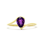 A product photo of a yellow gold amethyst ring sitting against a white background. The gold band is plain and smooth, and curves to meet at the top and bottom of a large, 7x5mm pear shaped amethyst centre stone - holding it in place.