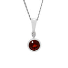 A product photo of a large, 6mm round garnet and diamond pendant suspended by a 9ct white gold chain over a plain white background. The 0.95ct garnet stone is a deep, dark red, and is set in a thick golden bezel setting.