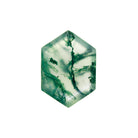 A product image of a loose 14x10mm faceted moss agate gemstone in the shape of an elongated hexagon. The stone has a cool white milky colour, with deep, swirling green natural inclusions - appearing as moss-like structures or delicate inkspills within the stone. The faceted edges reflect bright white light.