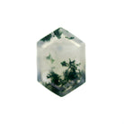 A product image of a loose 14x10mm faceted moss agate gemstone in the shape of an elongated hexagon. The stone has a cool white milky colour, with deep, swirling green natural inclusions - appearing as moss-like structures or delicate inkspills within the stone. The faceted edges reflect bright white light.