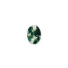 A product image of a loose 7x5mm cabochon oval-cut moss agate stone. The stone has a cool white milky colour, with deep, swirling green natural inclusions - appearing as moss-like structures or delicate inkspills within the stone. The faceted edges reflect bright white light.