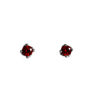 A product photo of 3mm Round garnet silver stud earrings sitting on a plain white background. The stones are held in place by 4 delicate silver claws arranged in a flower-like pattern where they meet the stud.