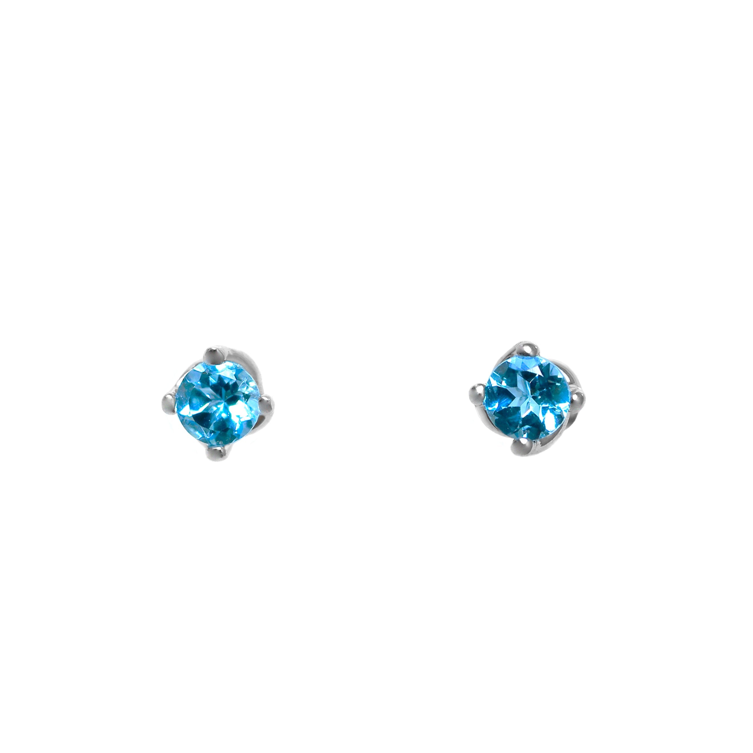 A product photo of 3mm Round Blue topaz silver stud earrings sitting on a plain white background. The stones are held in place by 4 delicate silver claws arranged in a flower-like pattern where they meet the stud.