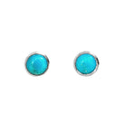 A product photo of a pair of silver Larimar gemstone stud earrings sitting against a white background. The 8mm round gemstones have dappled white and light blue patterning, similar to water reflections at the bottom of a pool, and are secured in place in bezel settings.