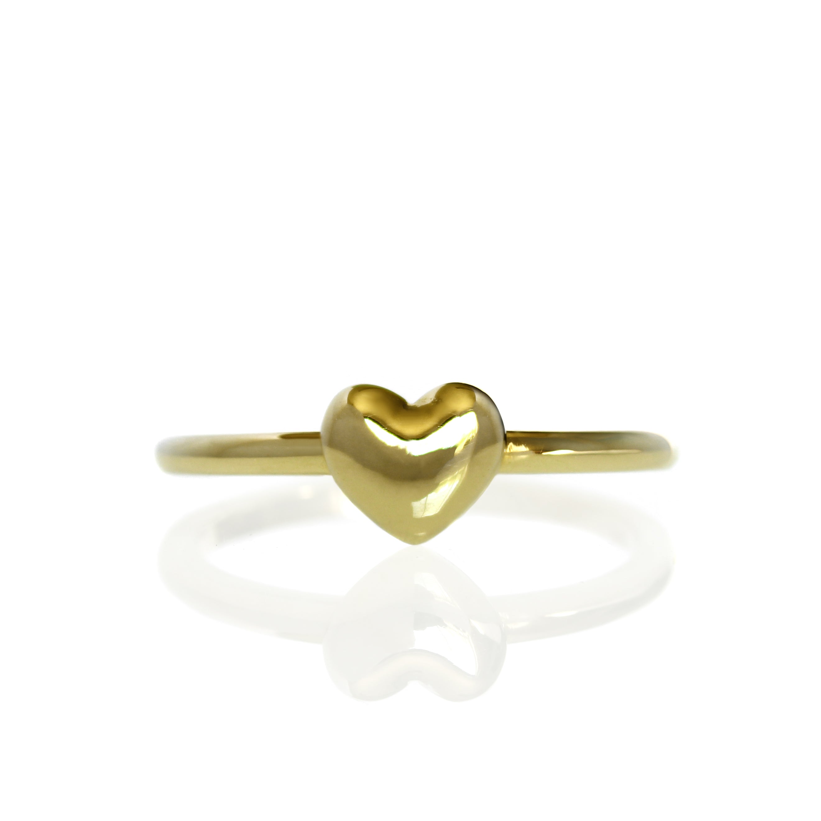 A product photo of a plain yellow gold heart ring on a white background. The ring's band is thick and rounded, meeting on either side of a small cushioned heart made of solid gold.