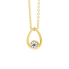 A product photo of a moissanite pendant in yellow gold sits on a clear white background. The pendant is in the shape of a small teardrop, with a petite gold-encased circle-cut moissanite gem nestled at its base. The yellow gold teardrop is smooth and unblemished.